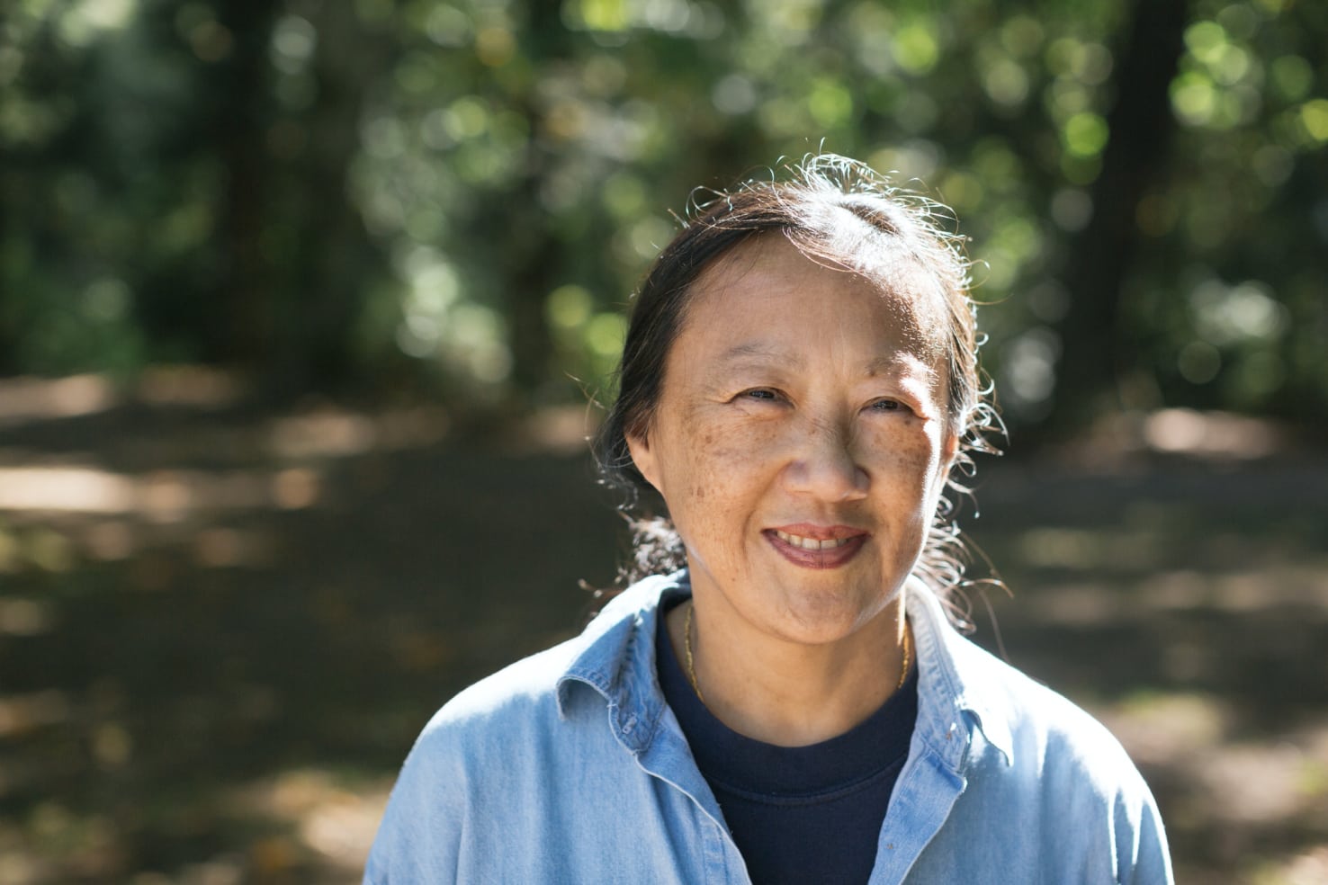 a woman in a park smiling