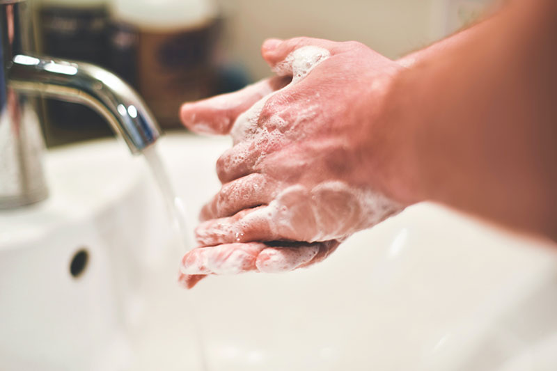 hands being washed at a faucet